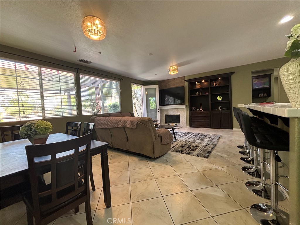 11571 Trailrun Court Riverside, CA 92505 - Photo 7 of 18 a living room with furniture a flat screen tv and a table