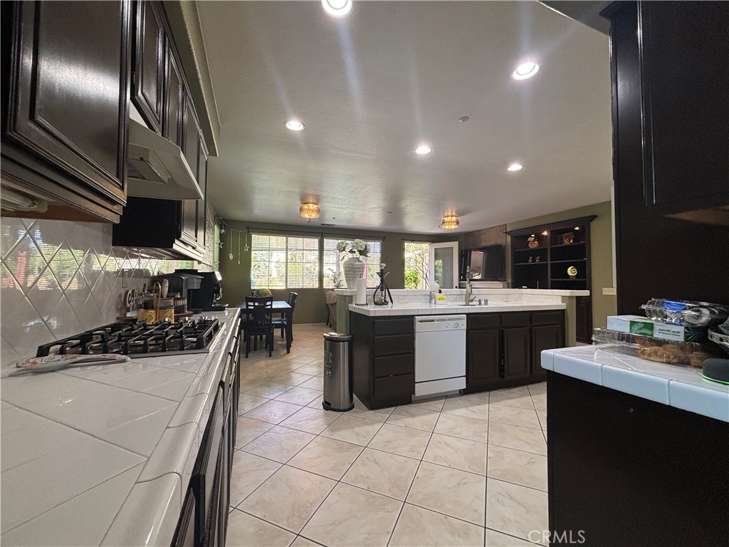 11571 Trailrun Court Riverside, CA 92505 - Photo 8 of 18 a kitchen with a sink appliances and cabinets