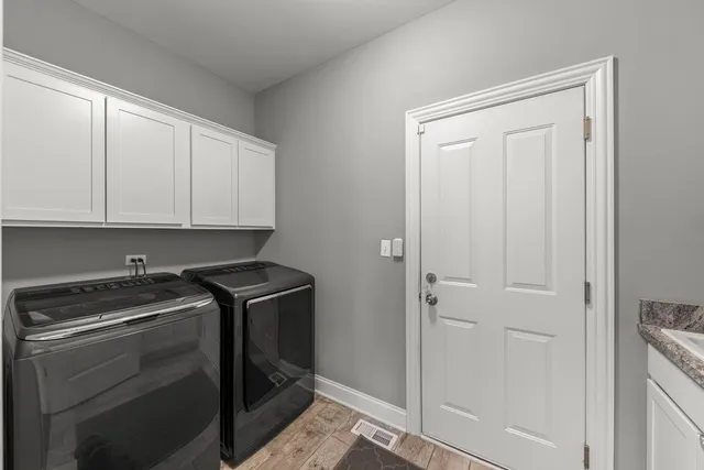 a view of a storage and utility room with washer and dryer