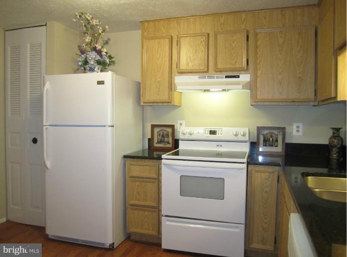 6226 Hillside Road Springfield, VA 22152 - Photo 13 of 30 a white refrigerator freezer sitting inside of a kitchen