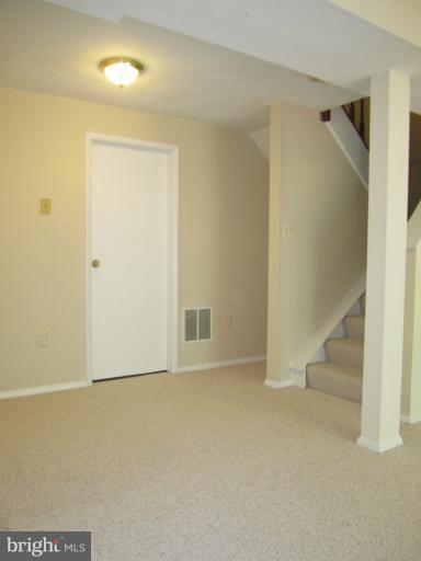 6226 Hillside Road Springfield, VA 22152 - Photo 16 of 30 an empty room with staircase and white walls