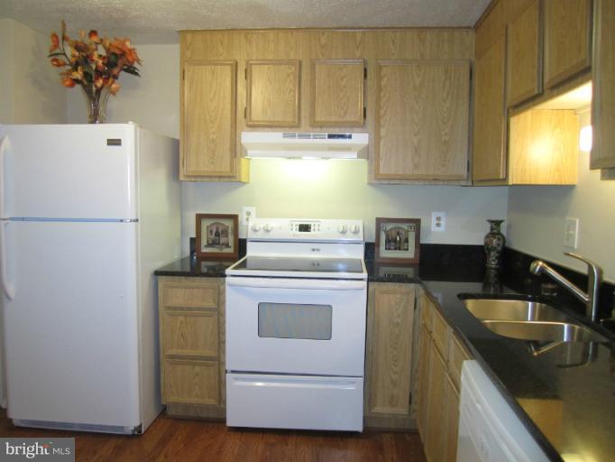 6226 Hillside Road Springfield, VA 22152 - Photo 21 of 30 a kitchen with a sink a stove and a refrigerator