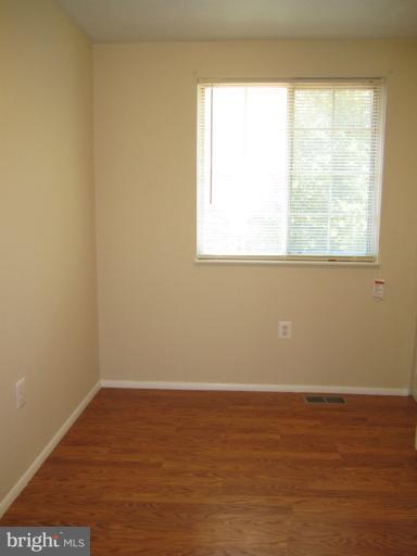 6226 Hillside Road Springfield, VA 22152 - Photo 22 of 30 a view of an empty room with wooden floor and a window