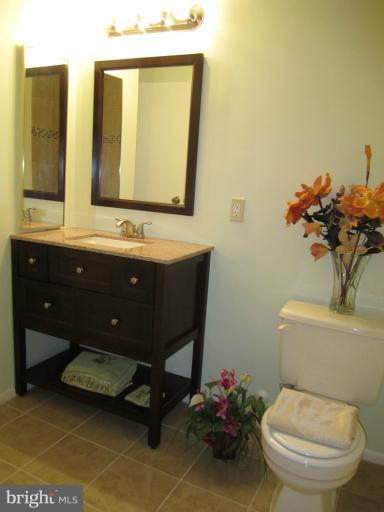 6226 Hillside Road Springfield, VA 22152 - Photo 30 of 30 a bathroom with a toilet sink and mirror