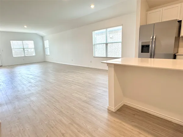 a view of an empty room and a bathroom