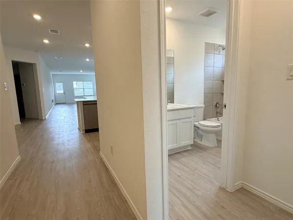 an empty room with closet and windows