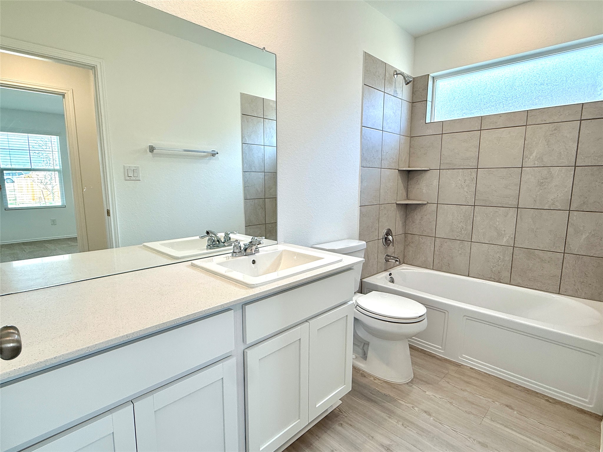 289 Sormonne Loop Kyle, TX 78640 - Photo 23 of 32 Full bathroom with vanity, shower / washtub combination, and light wood-style flooring