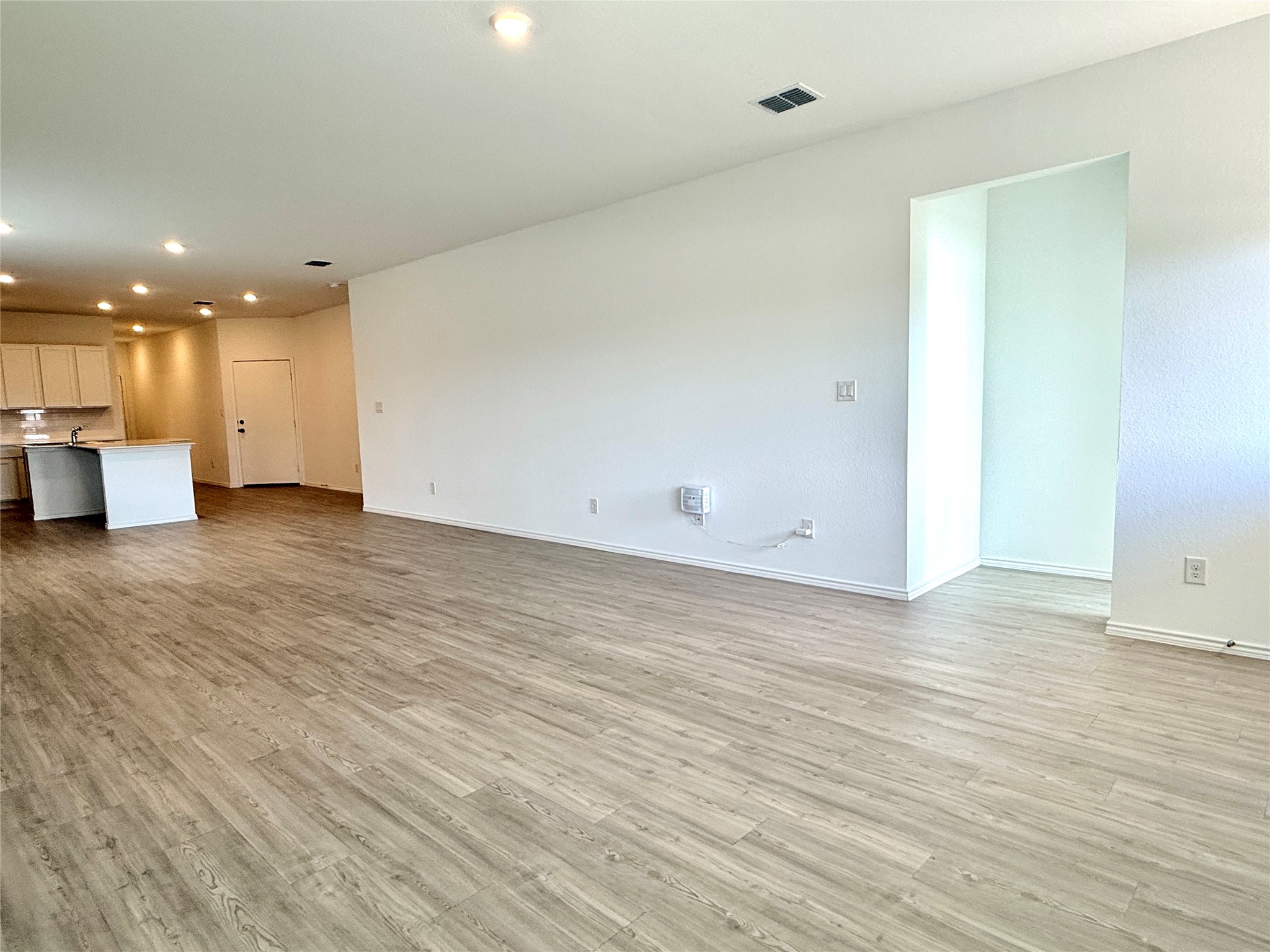 289 Sormonne Loop Kyle, TX 78640 - Photo 25 of 32 Unfurnished living room with recessed lighting and light wood-style flooring