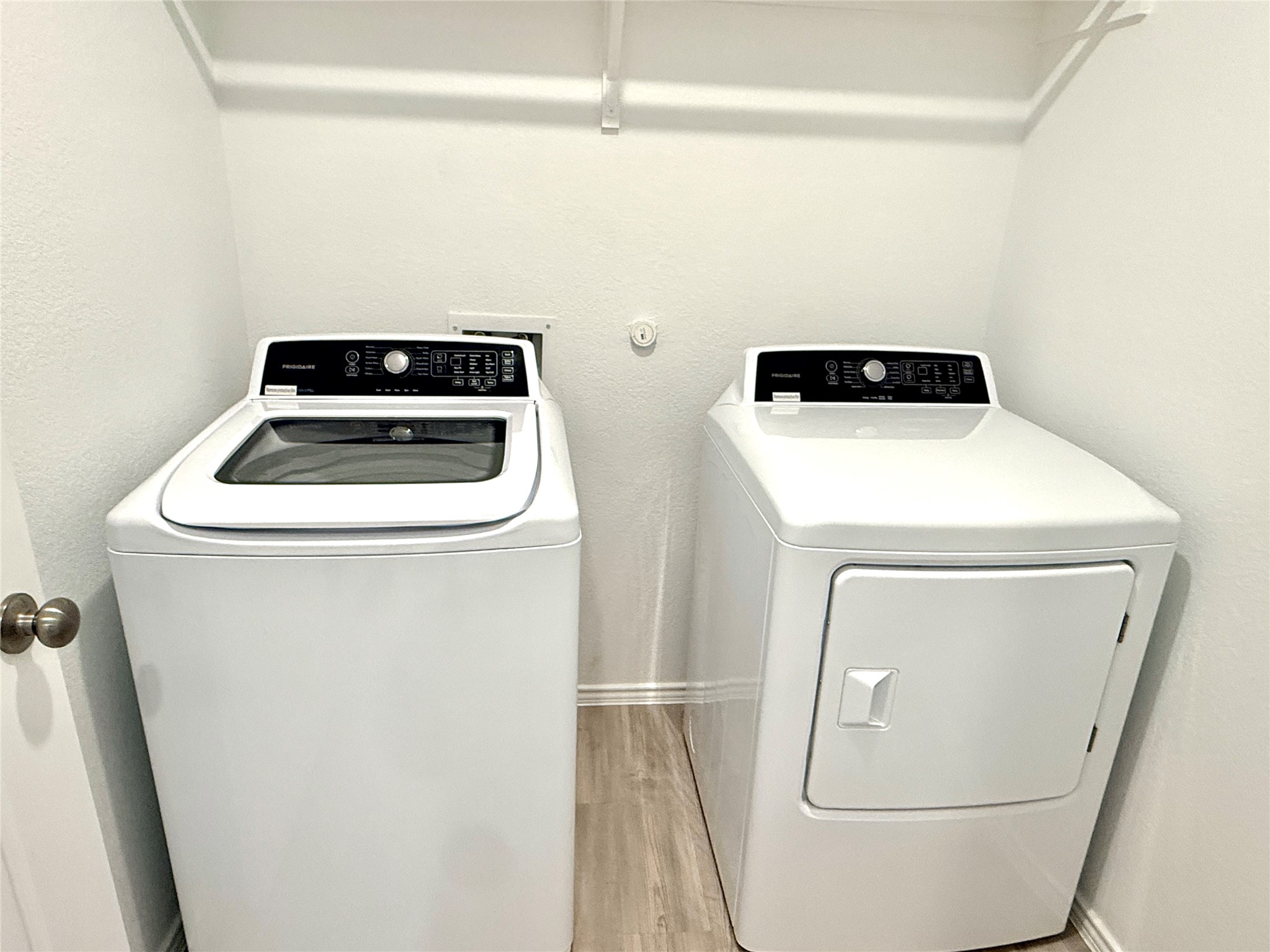 289 Sormonne Loop Kyle, TX 78640 - Photo 3 of 32 Laundry room featuring light wood-type flooring and washer and dryer