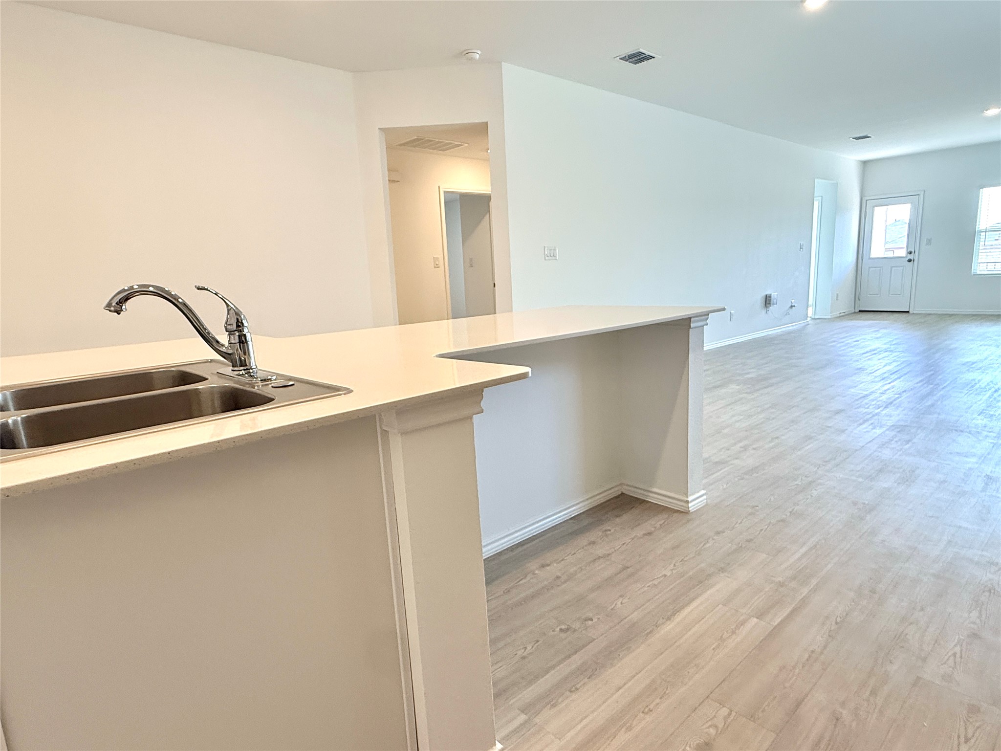 289 Sormonne Loop Kyle, TX 78640 - Photo 6 of 32 Kitchen featuring light wood-style floors and recessed lighting