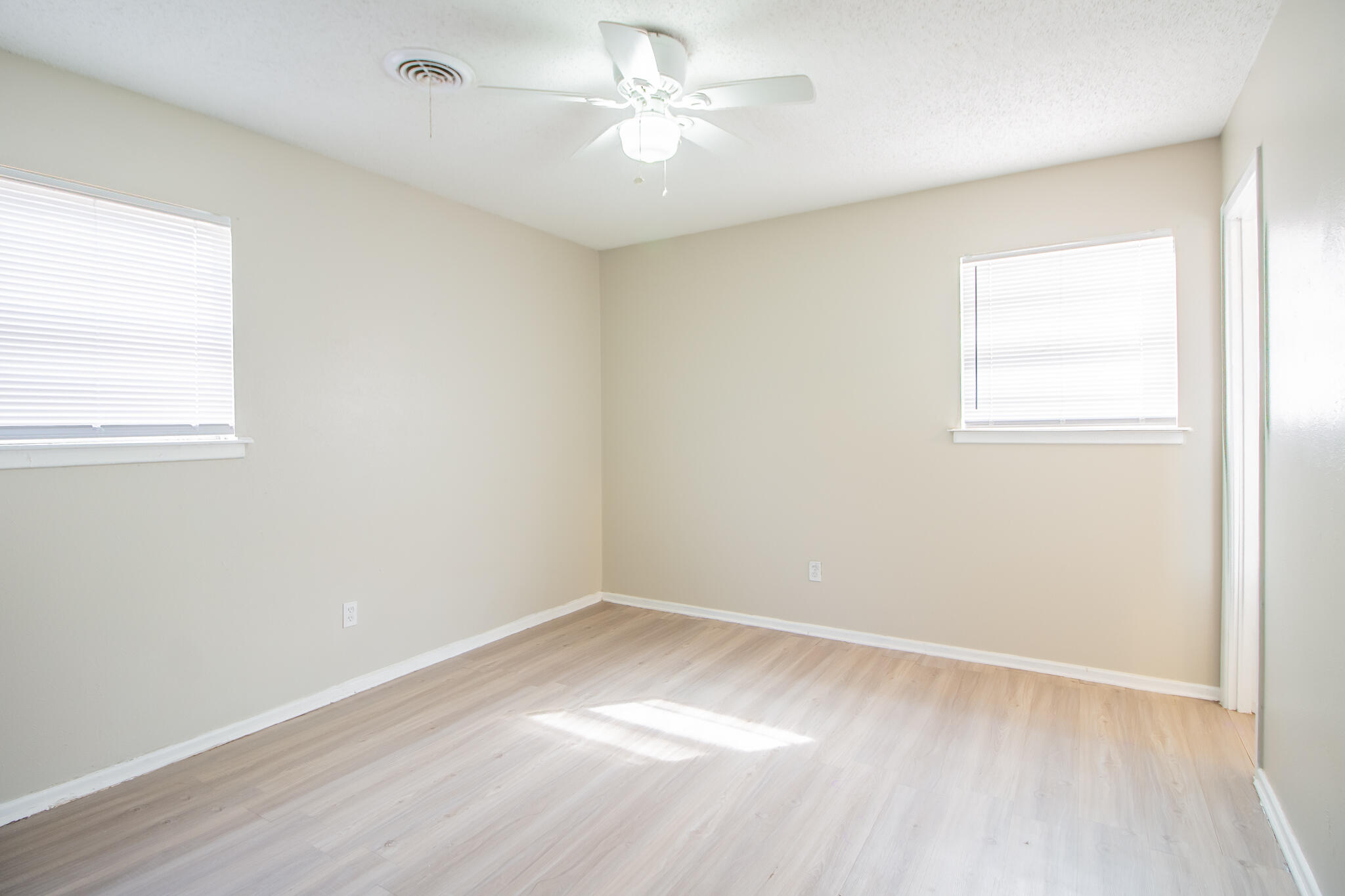 1903 71st Street Lubbock, TX 79412 - Photo 13 of 23 an empty room with a window and a fan