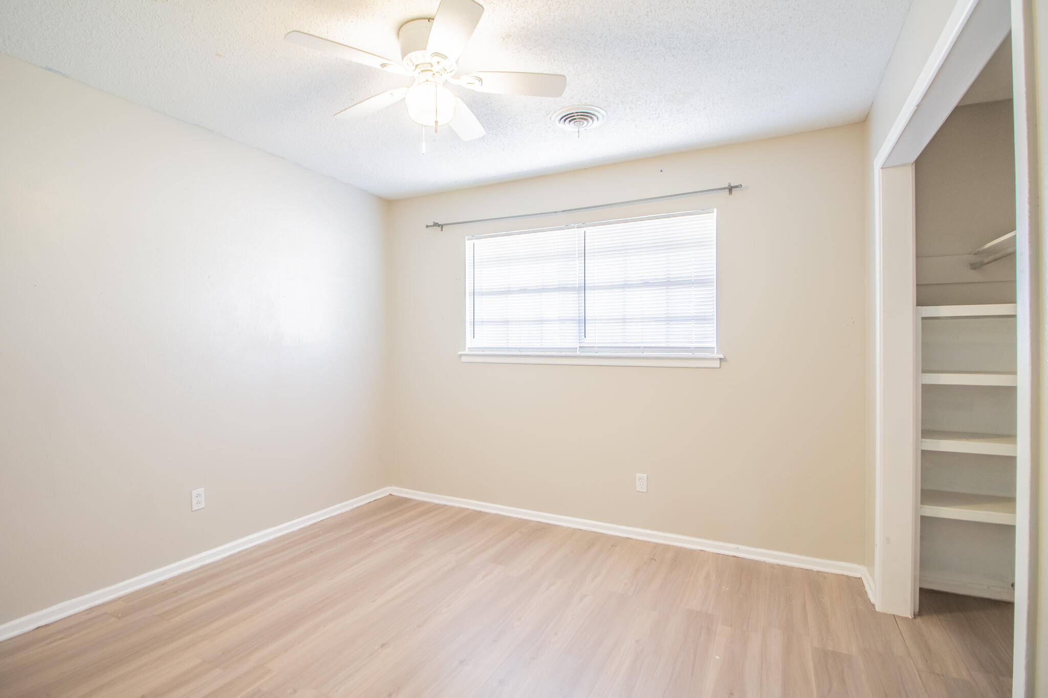 1903 71st Street Lubbock, TX 79412 - Photo 15 of 23 an empty room with a window and wooden floor