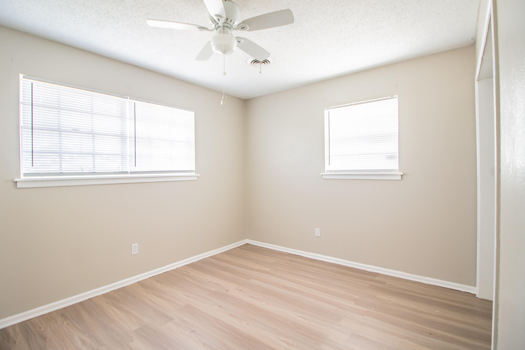 1903 71st Street Lubbock, TX 79412 - Photo 16 of 23 an empty room with a window and wooden floor