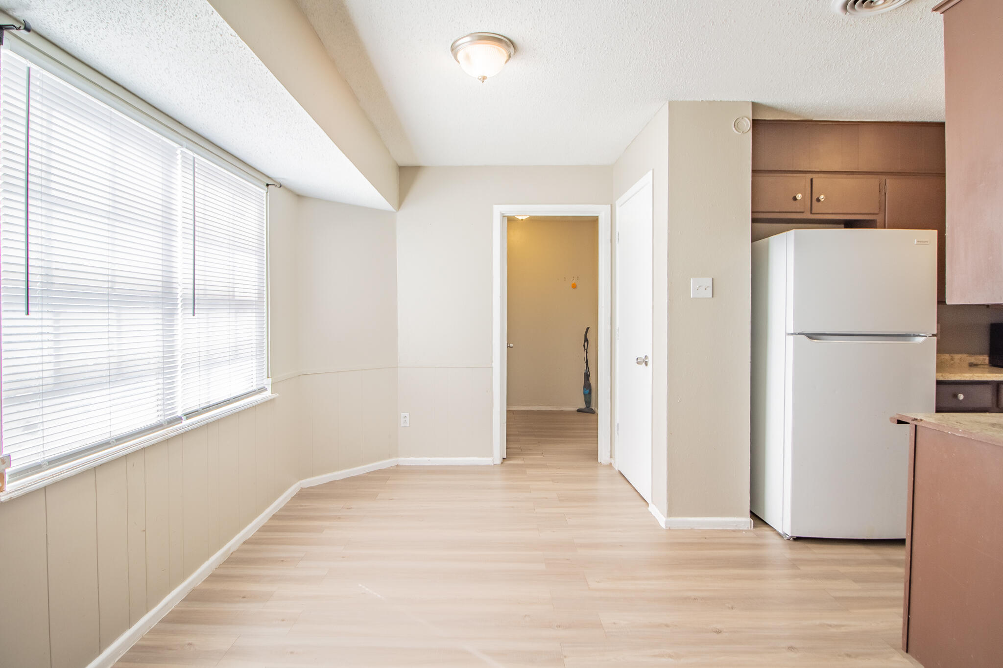 1903 71st Street Lubbock, TX 79412 - Photo 9 of 23 a view of a kitchen with a refrigerator and a window