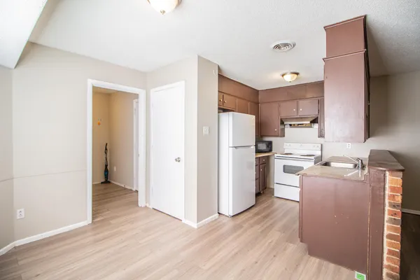 a kitchen with stainless steel appliances a refrigerator and a stove top oven