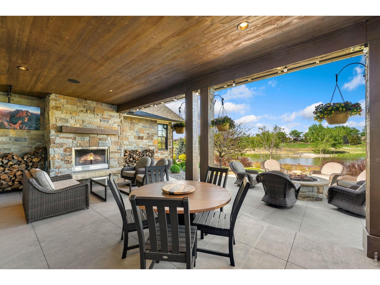 4252 Mountain Shadow Way Timnath, CO 80547 - Photo 42 of 49 Expansive covered outdoor living space featuring a wood-burning fireplace and a built-in gas fire pit