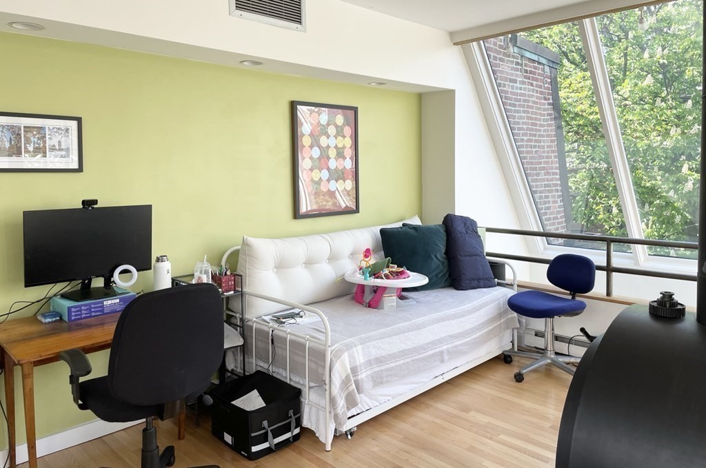 33 Lawrence Street, Unit 2 Boston, MA 02116 - Photo 12 of 38 a bedroom with a bed and large windows