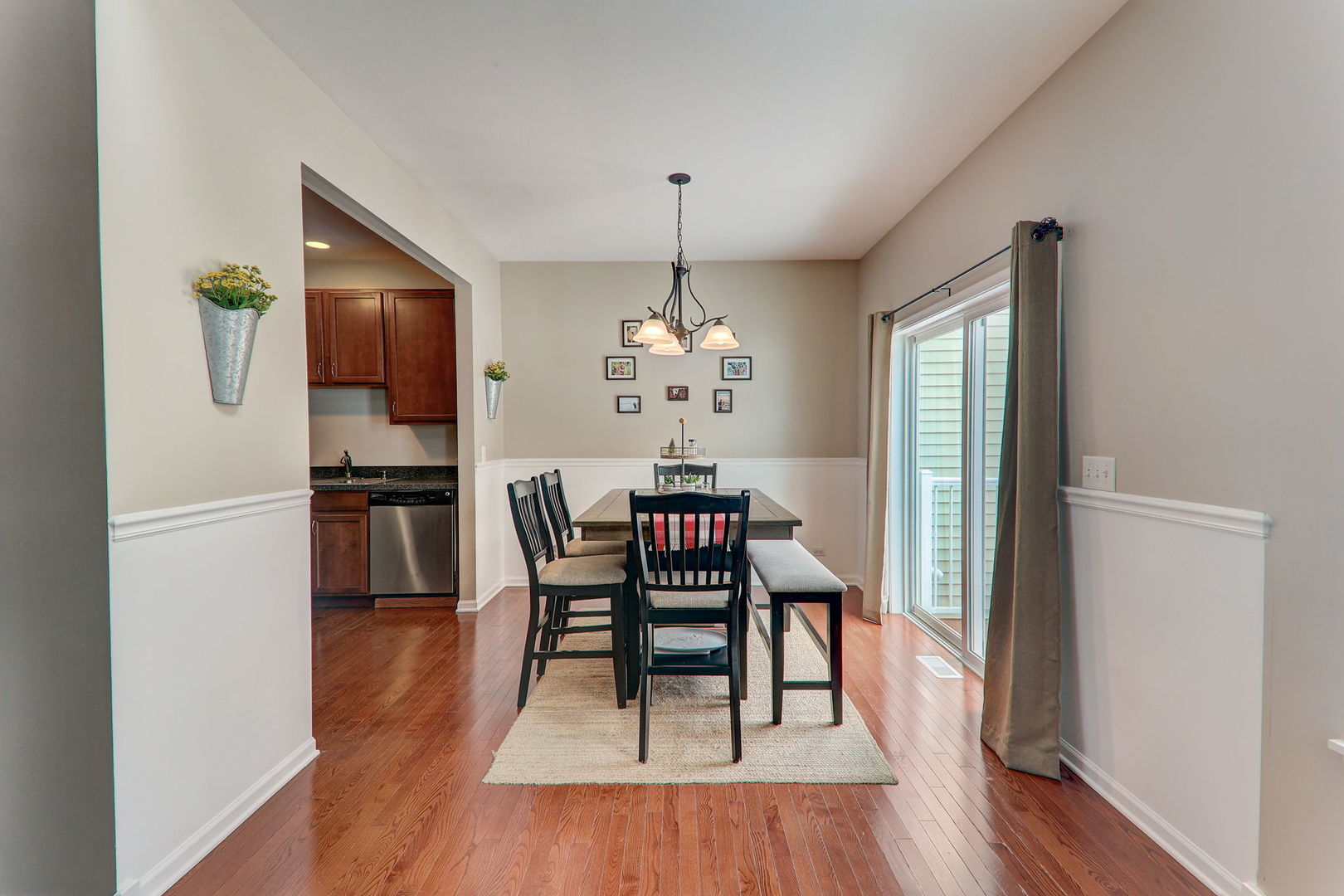 980 Oak Ridge Boulevard Elgin, IL 60120 - Photo 11 of 42 a dining room with furniture a chandelier and wooden floor