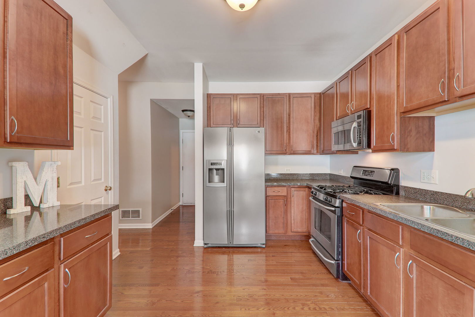 980 Oak Ridge Boulevard Elgin, IL 60120 - Photo 14 of 42 a kitchen with stainless steel appliances granite countertop a refrigerator stove top oven and sink