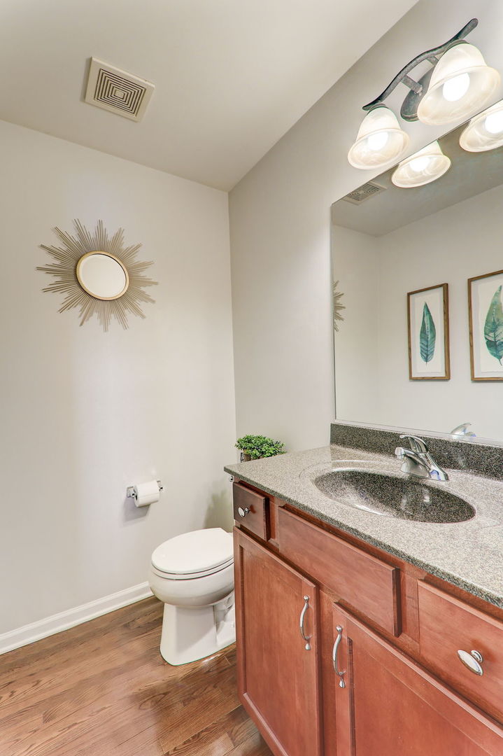 980 Oak Ridge Boulevard Elgin, IL 60120 - Photo 19 of 42 a bathroom with a granite countertop sink a toilet and a mirror