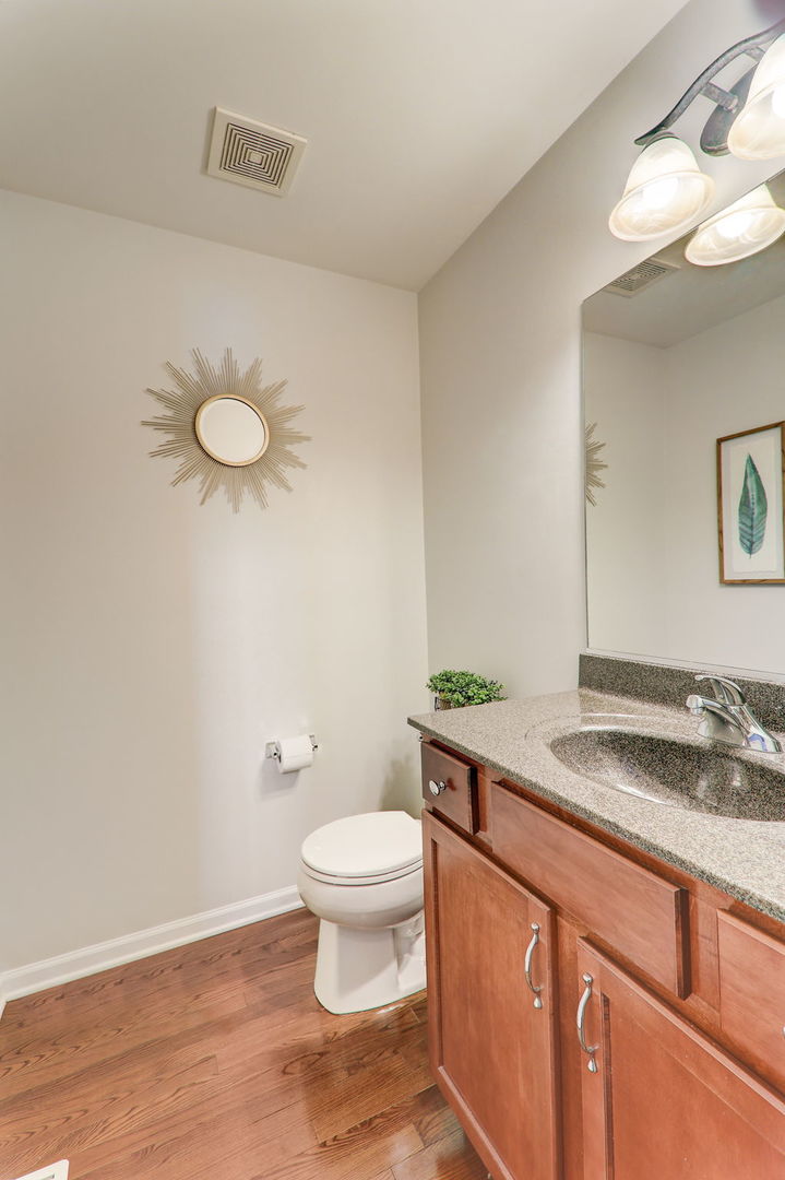 980 Oak Ridge Boulevard Elgin, IL 60120 - Photo 20 of 42 a bathroom with a granite countertop sink and a toilet