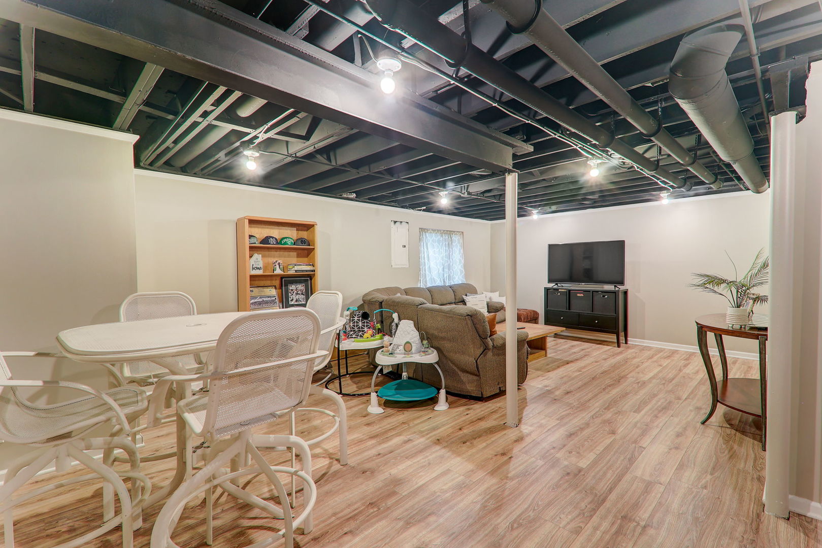 980 Oak Ridge Boulevard Elgin, IL 60120 - Photo 36 of 42 a living room with furniture a flat screen tv and a table