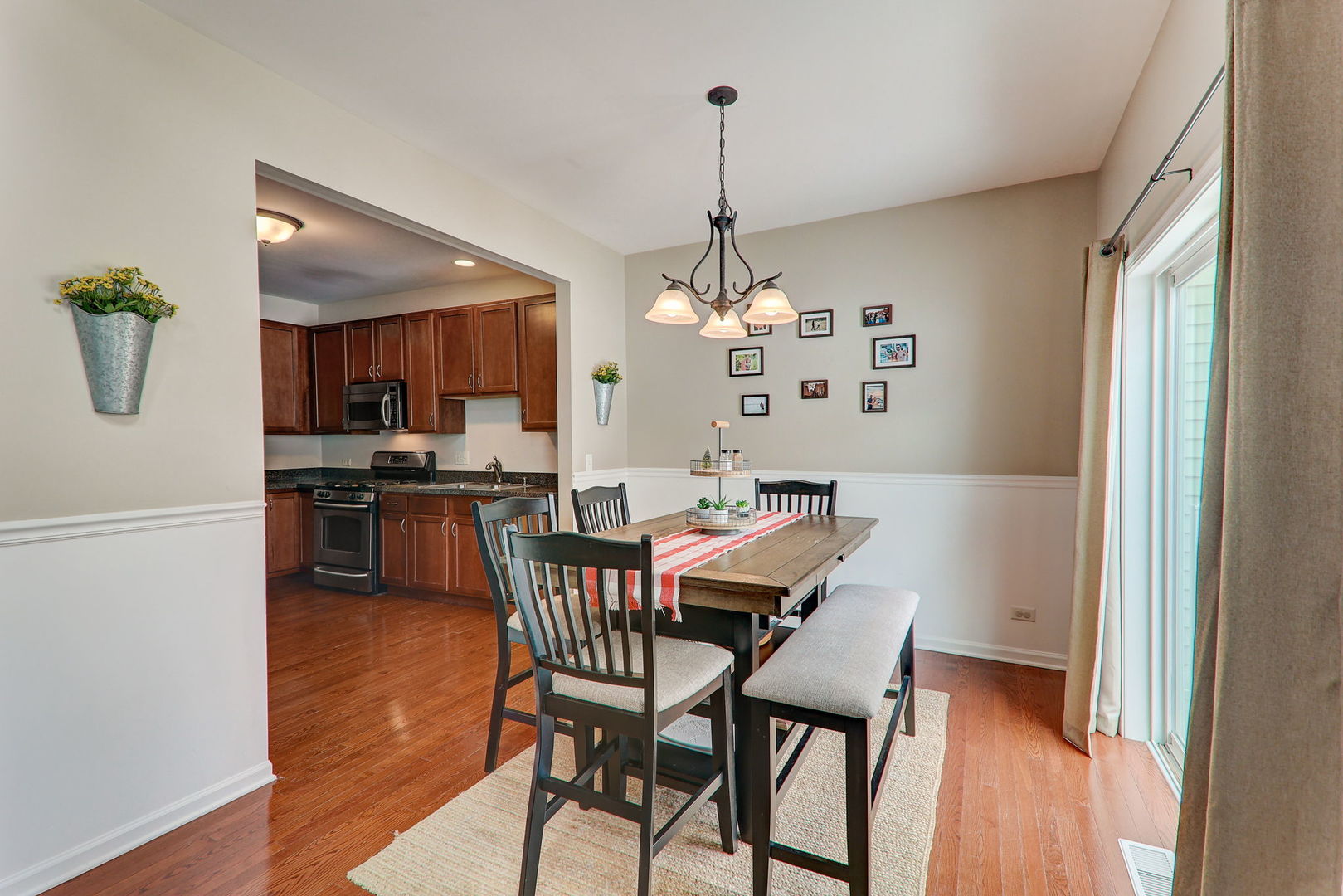 980 Oak Ridge Boulevard Elgin, IL 60120 - Photo 10 of 42 a view of a dining room with furniture wooden floor and a chandelier