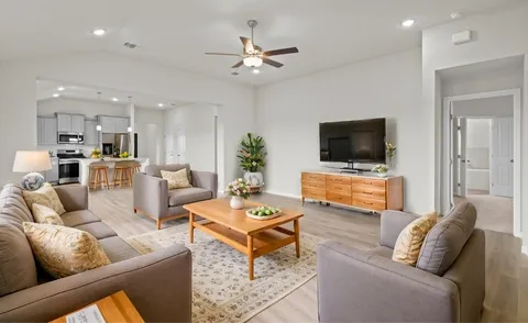 a living room with furniture and a flat screen tv