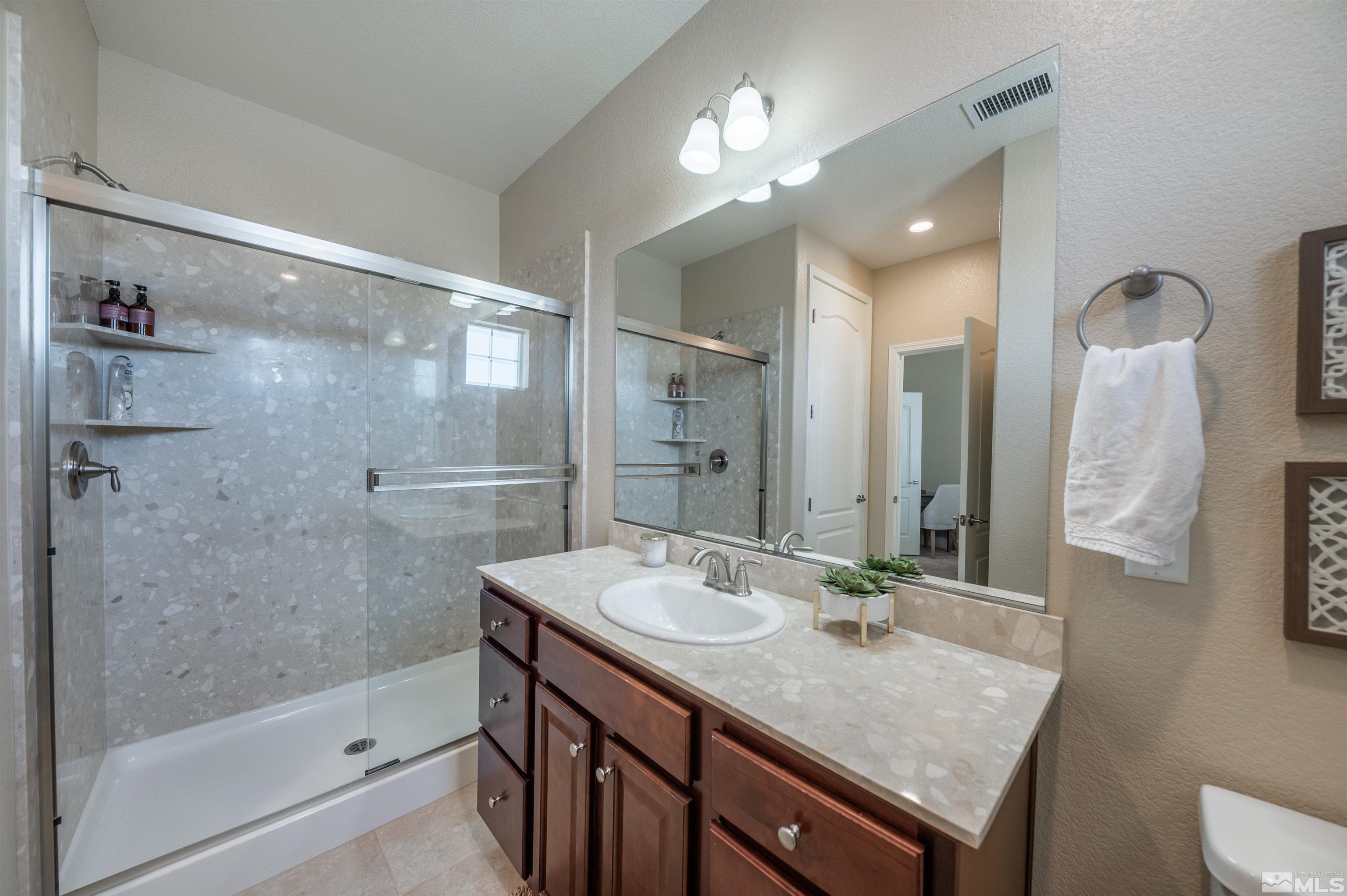10485 Mott Court Reno, NV 89521 - Photo 33 of 40 a bathroom with a sink a toilet and shower