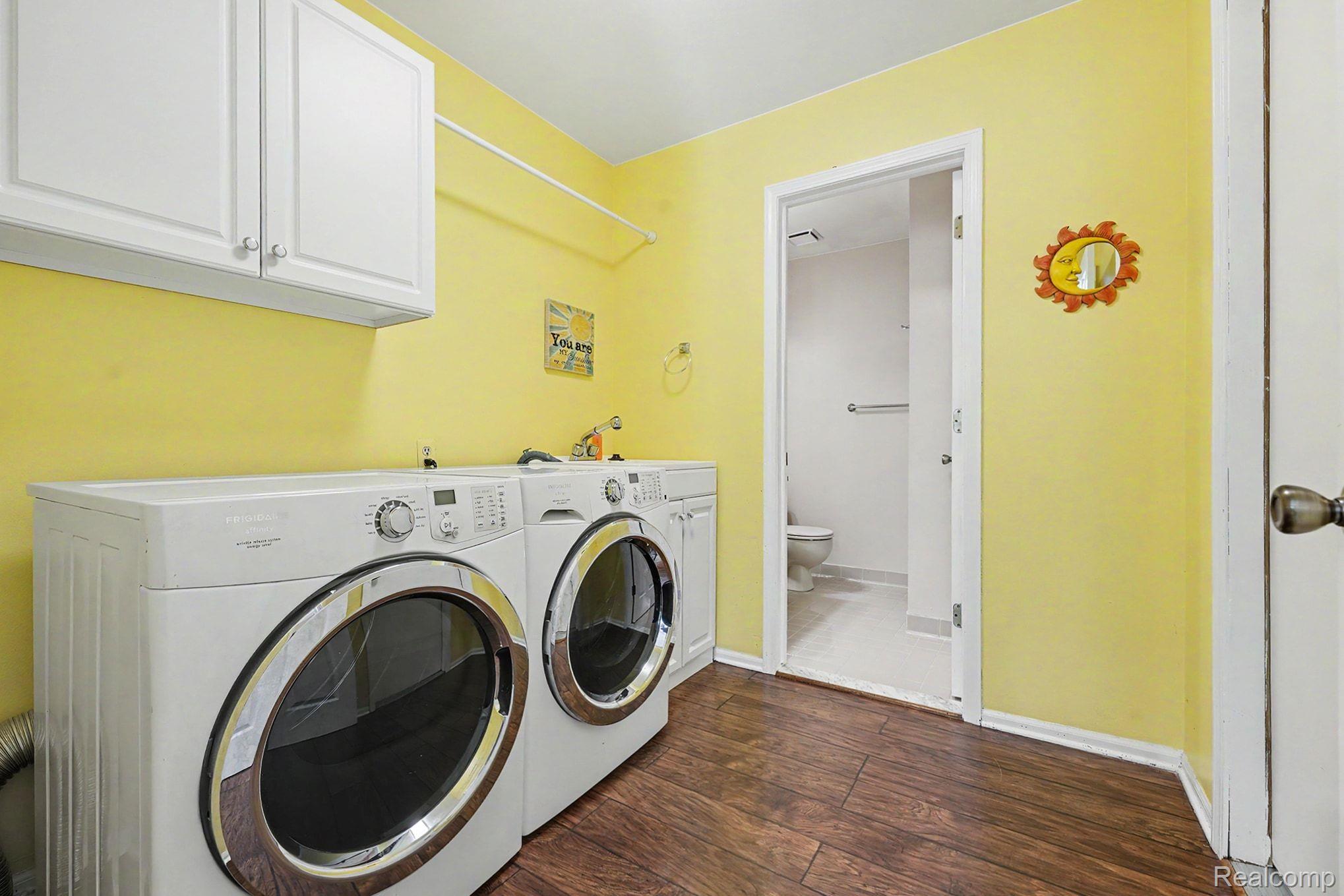 42619 Cedar Ridge Drive Clinton Township, MI 48038 - Photo 13 of 18 Dedicated laundry area featuring wood-finish flooring, white upper cabinetry, and a countertop with a utility sink