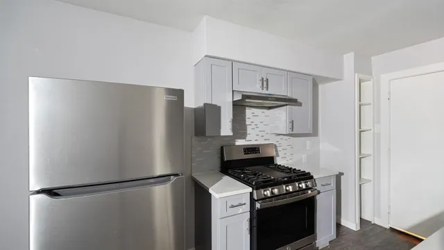 a kitchen with a stove and a refrigerator