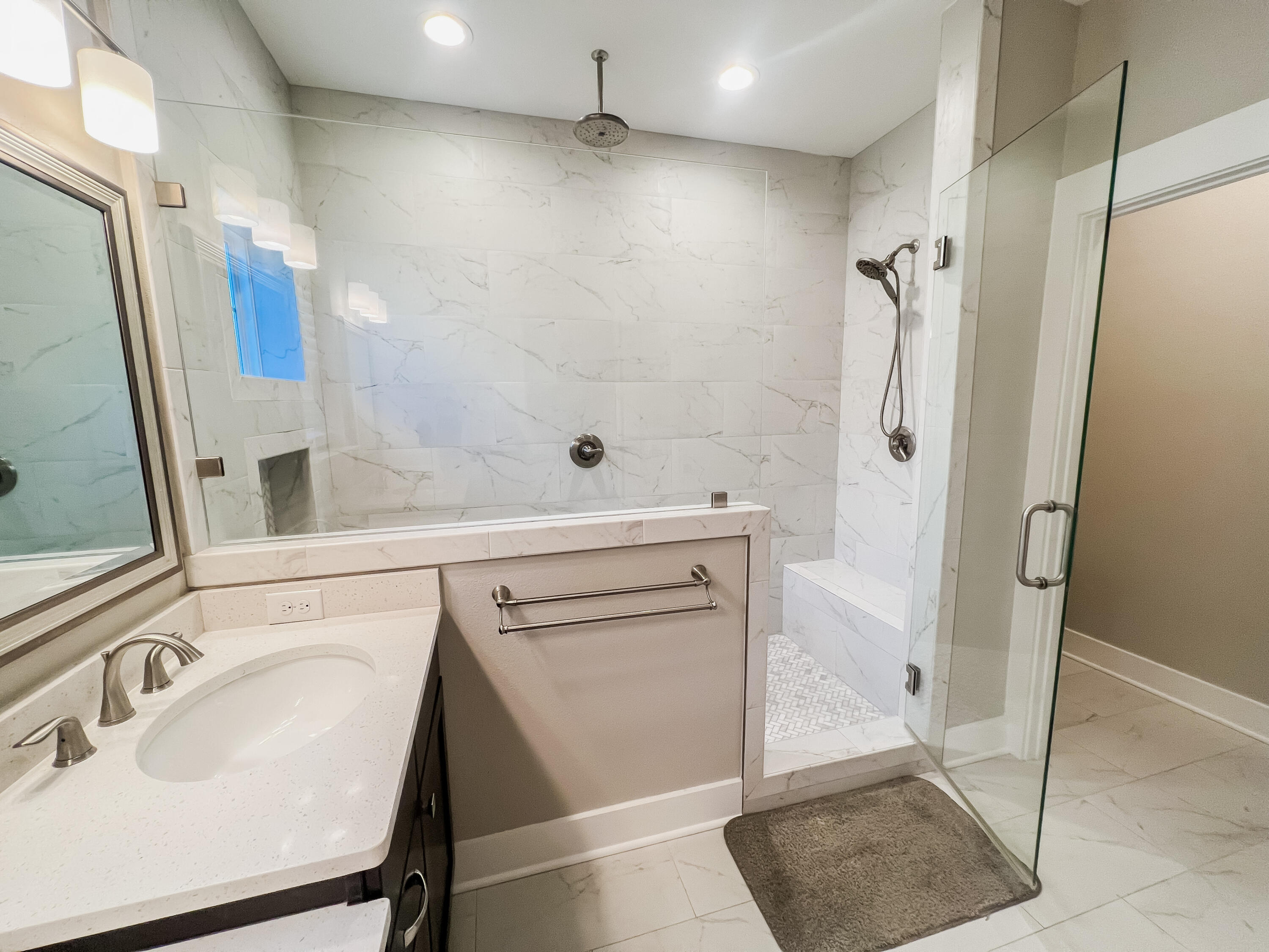 1159 Deer Moss Loop Niceville, FL 32578 - Photo 12 of 24 a bathroom with a sink a mirror and a shower