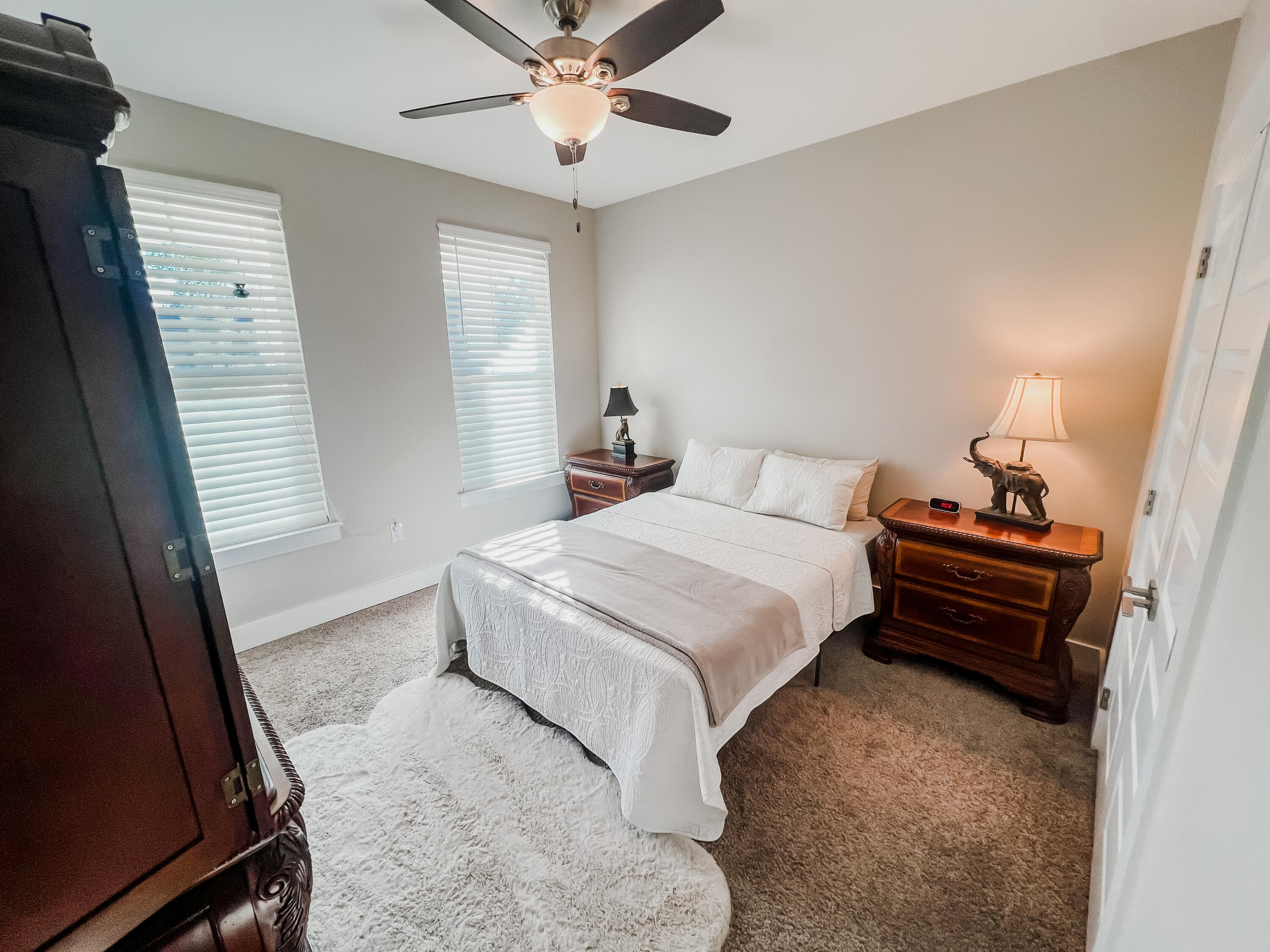 1159 Deer Moss Loop Niceville, FL 32578 - Photo 16 of 24 a bedroom with a bed and a chandelier