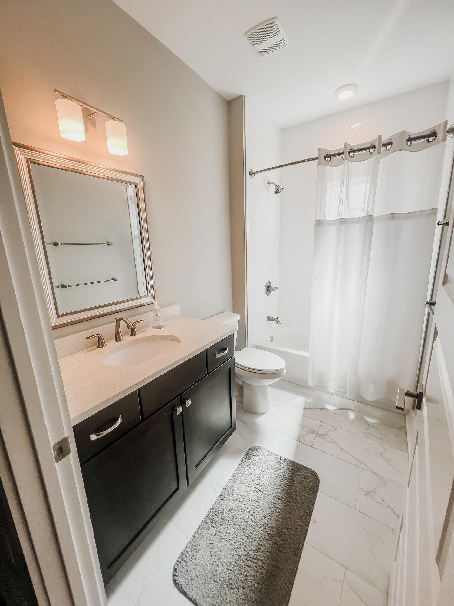 1159 Deer Moss Loop Niceville, FL 32578 - Photo 17 of 24 a bathroom with a sink a toilet a mirror and shower
