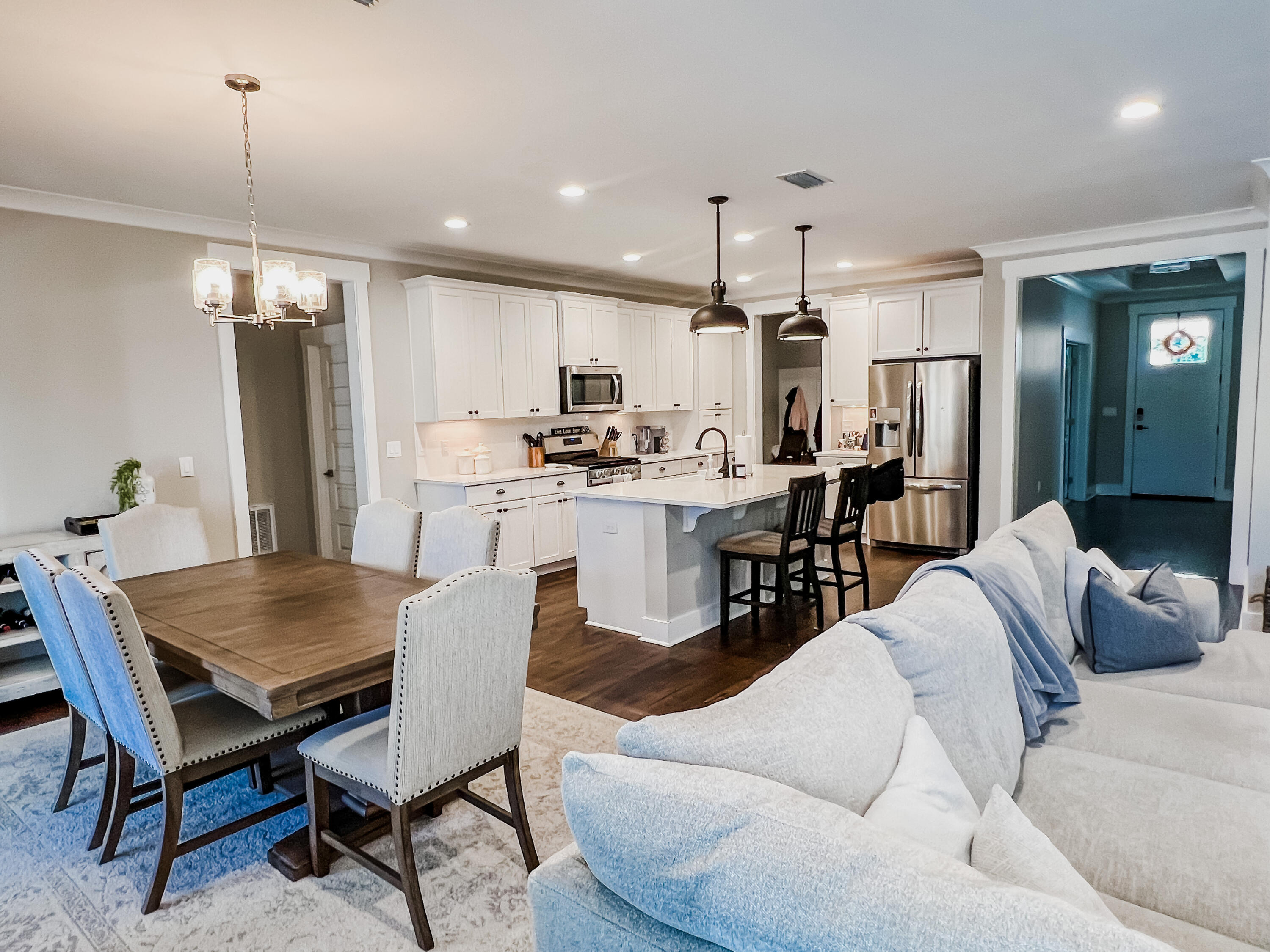 1159 Deer Moss Loop Niceville, FL 32578 - Photo 3 of 24 a view of a dining room and livingroom with furniture wooden floor a chandelier