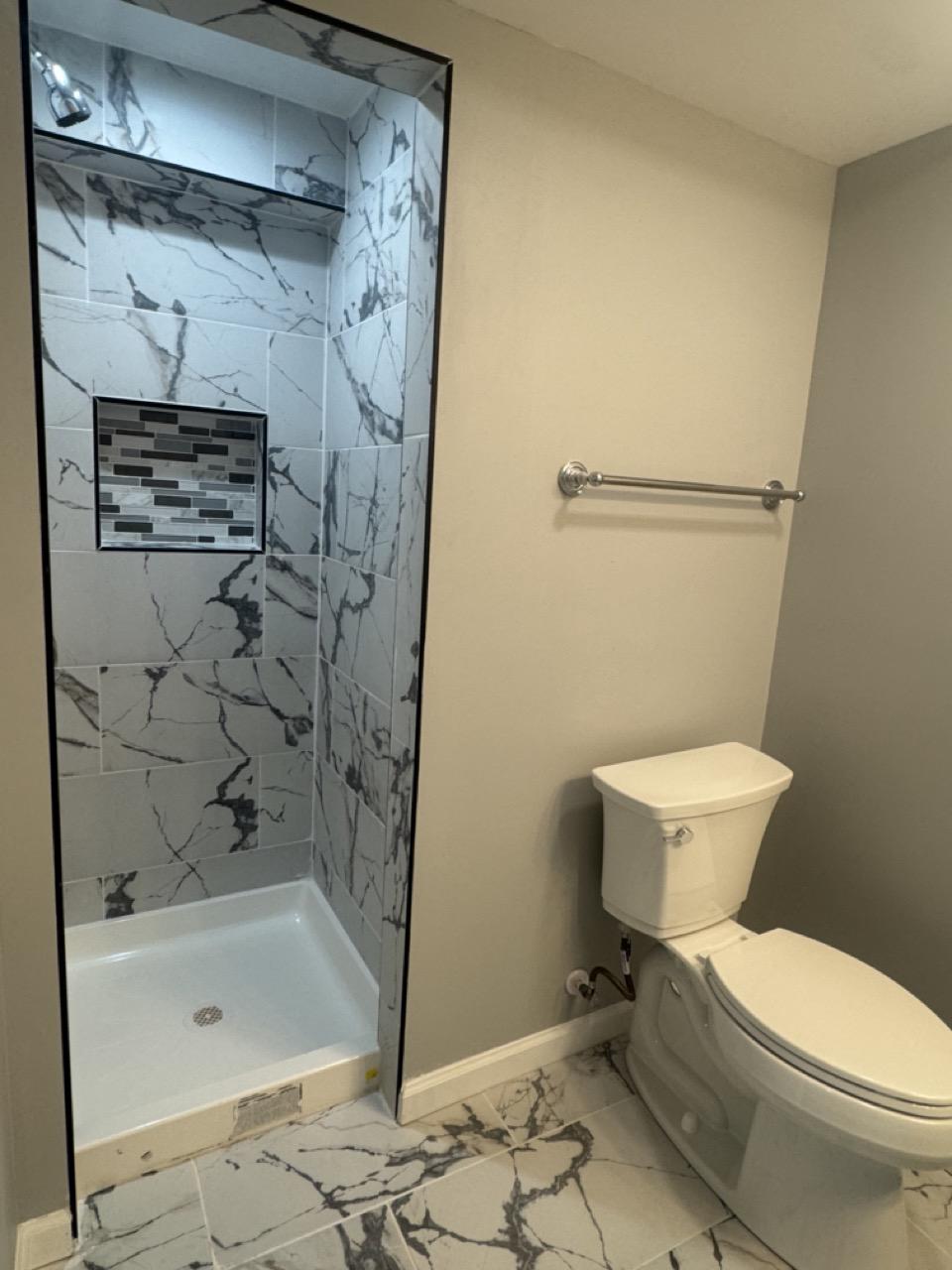 5626 Whitby Road Baltimore, MD 21206 - Photo 27 of 33 Sleek modern basement bathroom with elegant tiles.