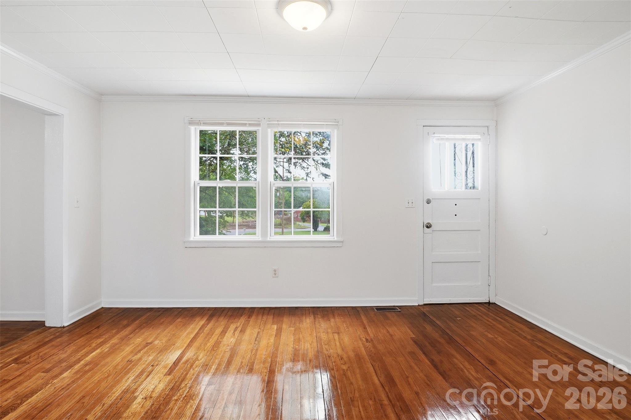128 Ella Street Chester, SC 29706 - Photo 15 of 18 an empty room with wooden floor and windows