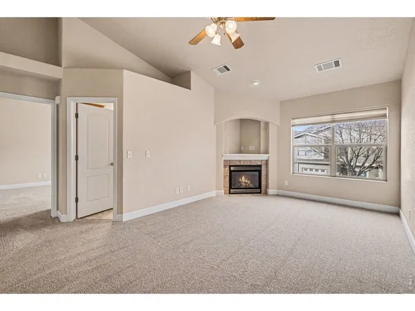 a view of an empty room with a fireplace