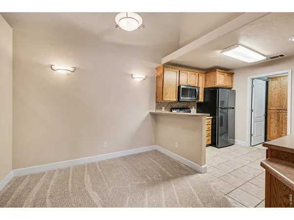 a kitchen with granite countertop a refrigerator and a sink