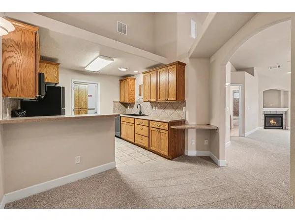 a kitchen with stainless steel appliances kitchen island granite countertop a stove a sink and a refrigerator