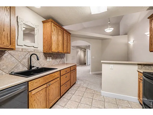 a kitchen with stainless steel appliances granite countertop a sink stove and cabinets