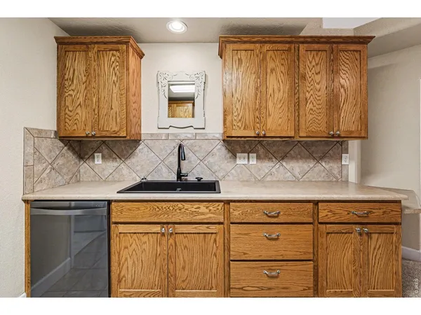 a kitchen with granite countertop cabinets and window
