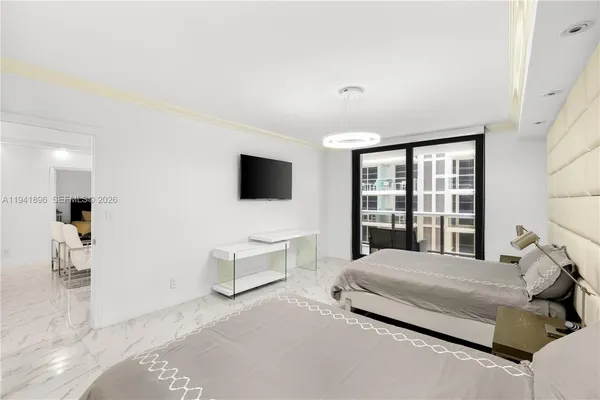 a bedroom with a bed and a flat screen tv