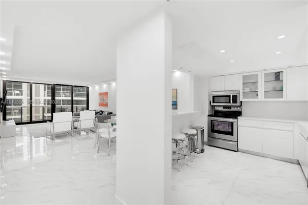 a kitchen with stainless steel appliances a refrigerator and a stove top oven