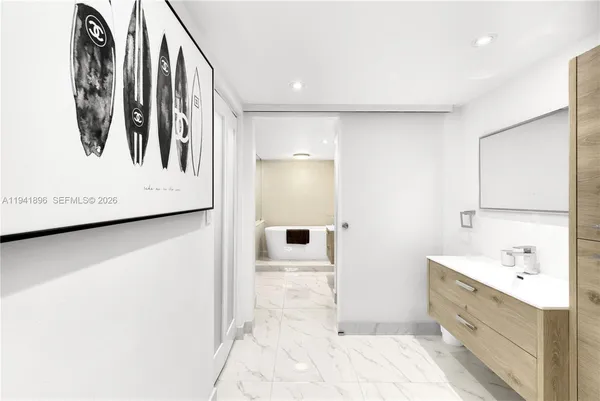 a bathroom with a shower sink and mirror