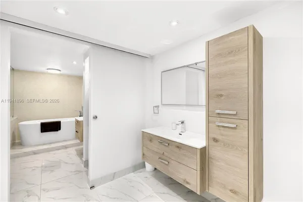 a bathroom with a bathtub and shower