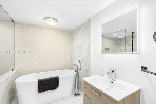 a bathroom with a bathtub and a shower