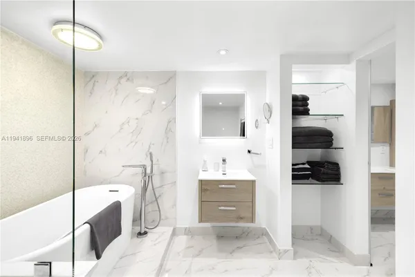 a bathroom with a sink a bathtub and a shower