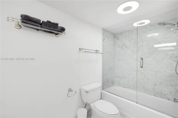 a bathroom with a granite countertop sink mirror and vanity