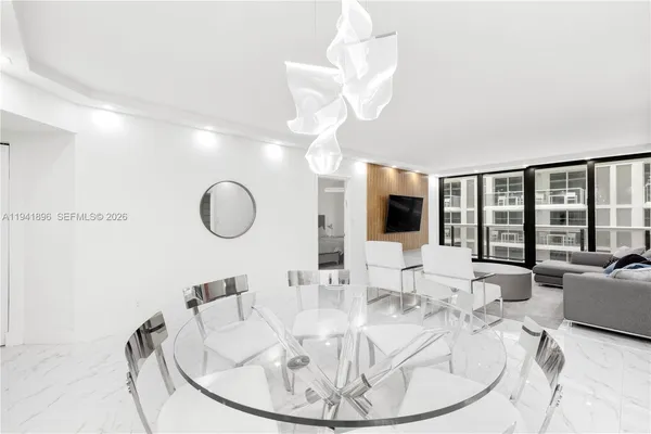 a work place with large window and furniture